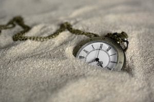 pocket watch in sand